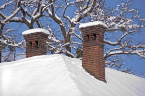 snowy roof with masonry chimneys
