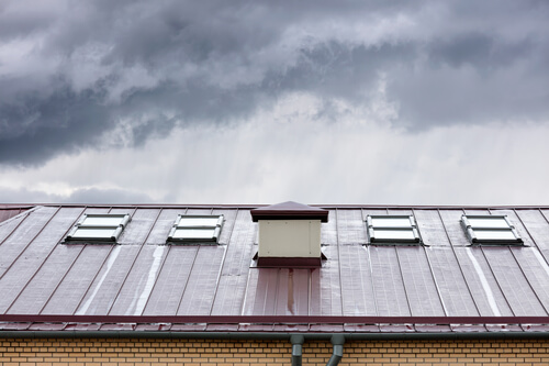 rainy skies over a red roof with chimney - Elkton MD - Ace Chimney Sweeps